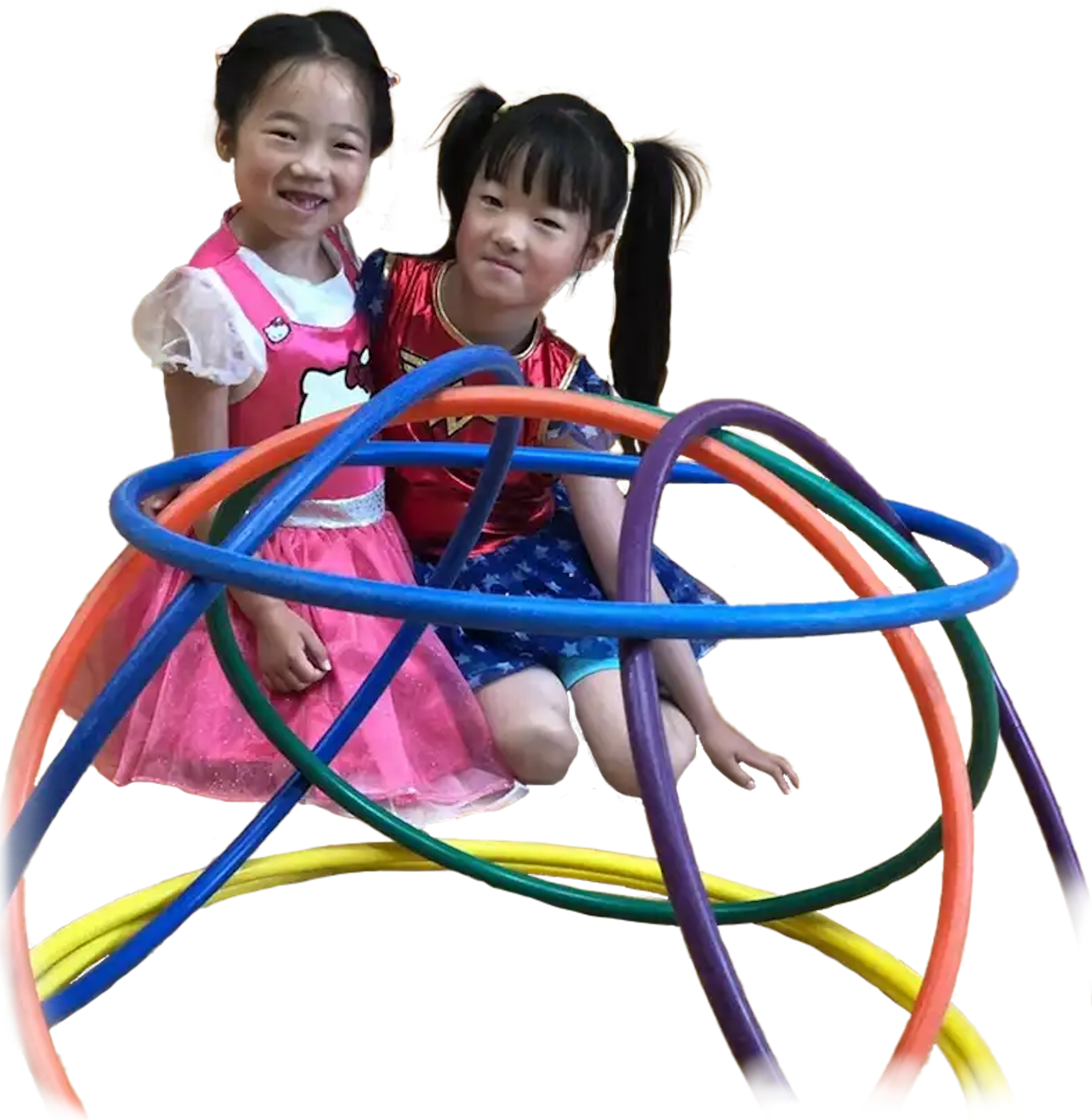 Two school girls building a structure out of hula hoops